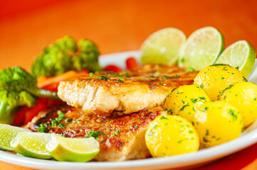 fish fillet with vegetables and boiled soute potatoes.