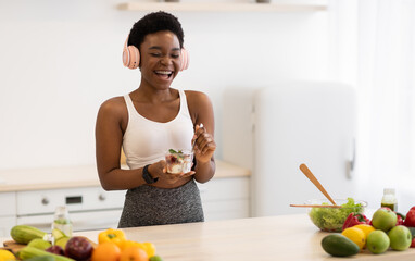 Healthy Sweets. African Fitness Lady Eating Yogurt With Granola And Laughing Standing In Modern...