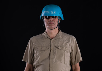 portrait of a man military press with video camera on black background