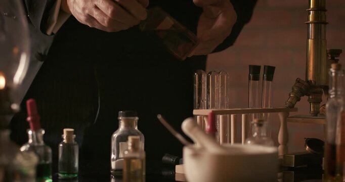 closeup of vintage scientist looking at a bottle of liquid