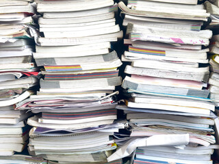 Piles of waste paper waiting to be recycled.pile of textbooks collected at school at the end of the year