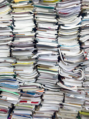 Piles of waste paper waiting to be recycled.pile of textbooks collected at school at the end of the...