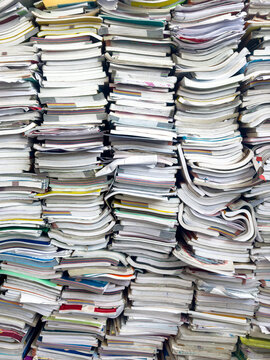 Piles of waste paper waiting to be recycled.pile of textbooks collected at school at the end of the year