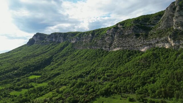 Panoramic mountain view near the village of Saou in the Drome department in France of the Vercors hills, the marly hills and the Val de Drome valley. The Saou forest and the 3 peaks - Drome Valley