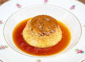 dessert flan with milk on a white plate
