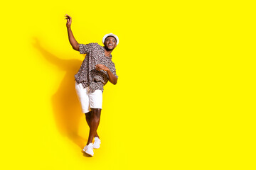 Photo of cheerful glad man wear stylish clothes empty space isolated on vibrant yellow color background
