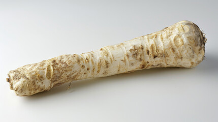 A whole horseradish isolated on a white background