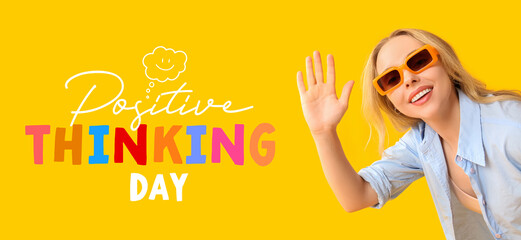 Young beautiful woman waving hand on yellow background