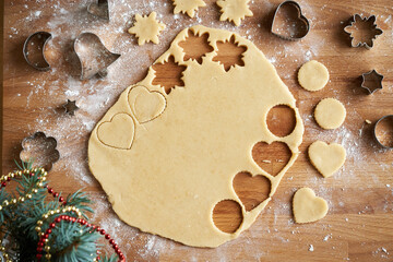 Cutting out star and circle shapes from rolled out dough to prepare traditional Linzer Christmas cookies, top view