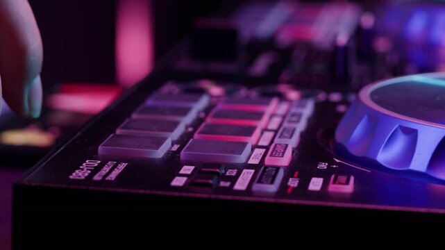 DJ playing music on festival in night club. Techno musician with headphones and sunglasses performing at nightclub for concert crowd of people, city bar.