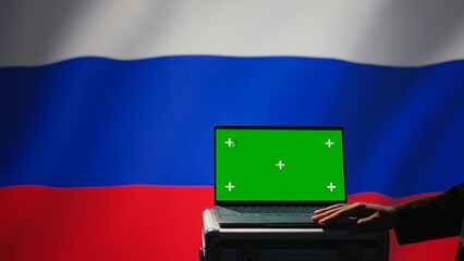 Russian soldier using military tech on green screen laptop to identify threats from enemies. Russia...