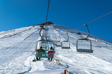 View of El Colorado ski resort in Farellones, Chile on a sunny winter day, showcasing the stunning snow-covered Andes mountains and ski slopes.