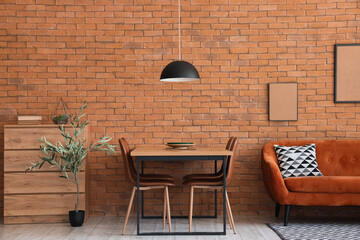Stylish interior of light dining room with cozy sofa and chest of drawers