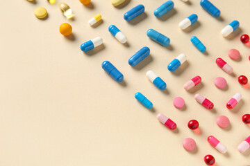 Different pills on beige background, closeup