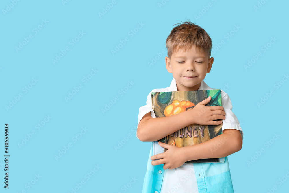 Poster Portrait of cute little boy with closed eyes and book on blue background