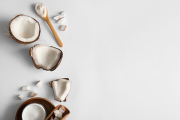 Fototapeta premium Wooden spoon and jar of coconut cosmetic cream on grey background