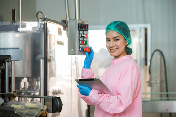 Worker Checking quality or checking stock of glass bottle in beverage factory. Worker QC working in a drink water factory