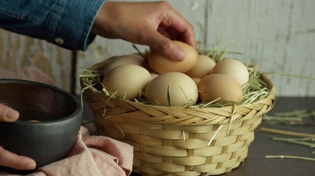 Latin woman places new eggs on a woven basket, Till up video
