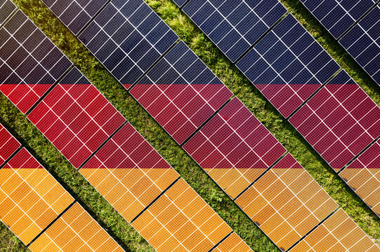 Solar farm superimposed with flag of Germany. Symbolizing solar power and panel demand, renewable energy industry, government policy, and sustainability initiatives in the country.