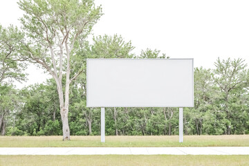 Blank Billboard with a Green Tree and Grass Background