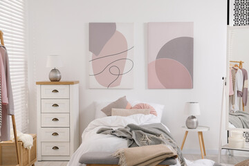 Teen's room interior with modern furniture and beautiful pictures on wall
