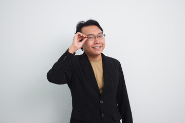 Happy asian businessman Holding eyelet of glasses isolated white background