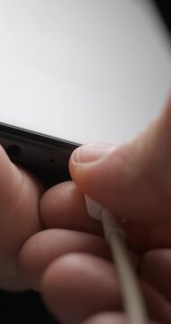 USB-C cable macro plugin to smartphone slow motion, vertical view