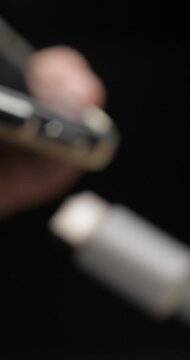 USB-C cable macro plugin to smartphone slow motion, vertical view