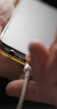 USB-C cable macro plugin to smartphone slow motion, vertical view