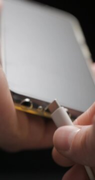 USB-C cable macro plugin to smartphone slow motion, vertical view