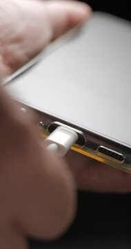USB-C cable macro plugin to smartphone slow motion, vertical view