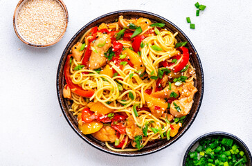 Egg noodles with stir fried chicken, pineapple, paprika, green onion, ginger, garlic, soy sauce and sesame seeds. White background, top view