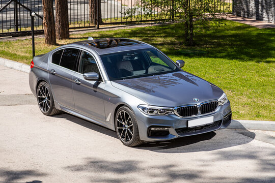 Novosibirsk, Russia -  July 10, 2024: BMW 5-series,  parked on the street on a warm summer day against the backdrop of  park