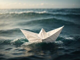 White paper boat floating on the waves closeup