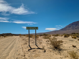 Dirt road in the desert of northern Argentina with signpost