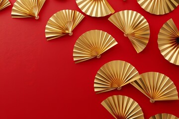 Golden hand fans on red background, festive Asian decor.