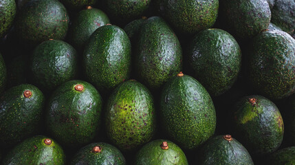 Fresh green avocados texture background placed together in a big pile. concept of healthy diet