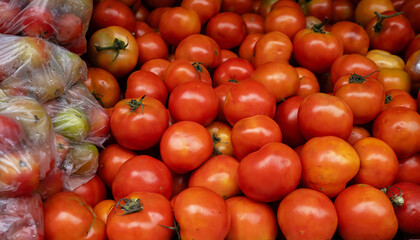 Fresh red tomatoes background placed together in a big pile at supermarket. concept of healthy diet