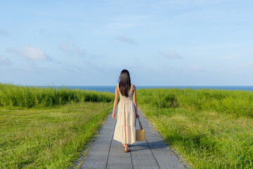 Woman walk in the seaside park