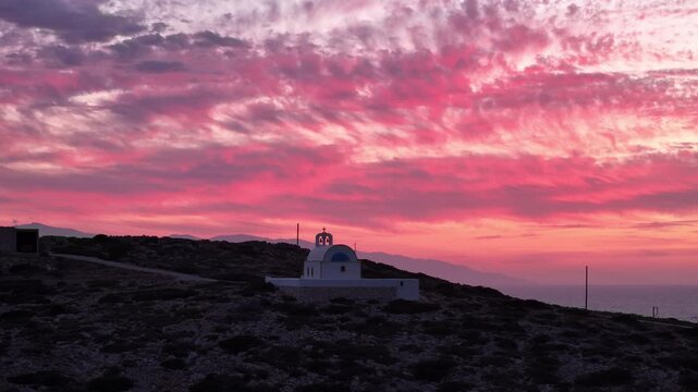Soft pastel glow in sky behind Holy Wisdom church in Donousa Greece at sunset