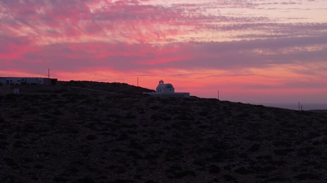 Panoramic orbit around Holy Wisdom church in Donousa Greece at stunning sunset