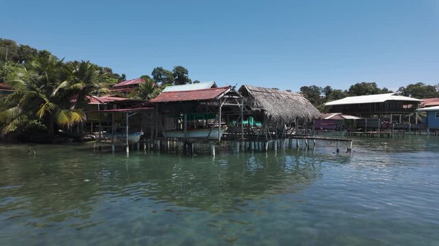 Scenic view of traditional coastal village huts over clear waters on Bastimentos Island, Bocas del Toro, Panama.
