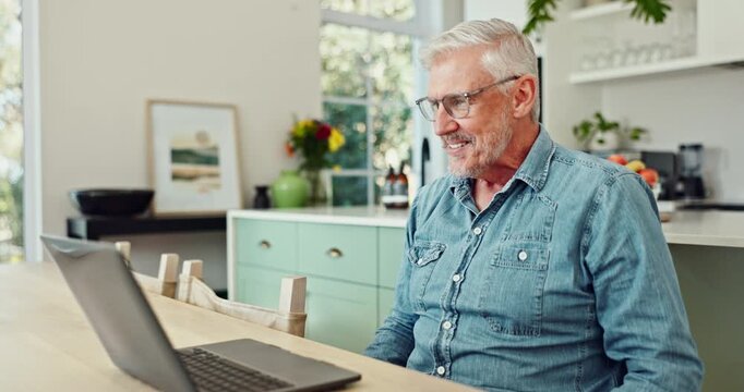 Laptop, happy and mature man in kitchen with pride and satisfaction for winning online bet. Excited, celebration and senior male person read good news email on computer for investment profit at home.