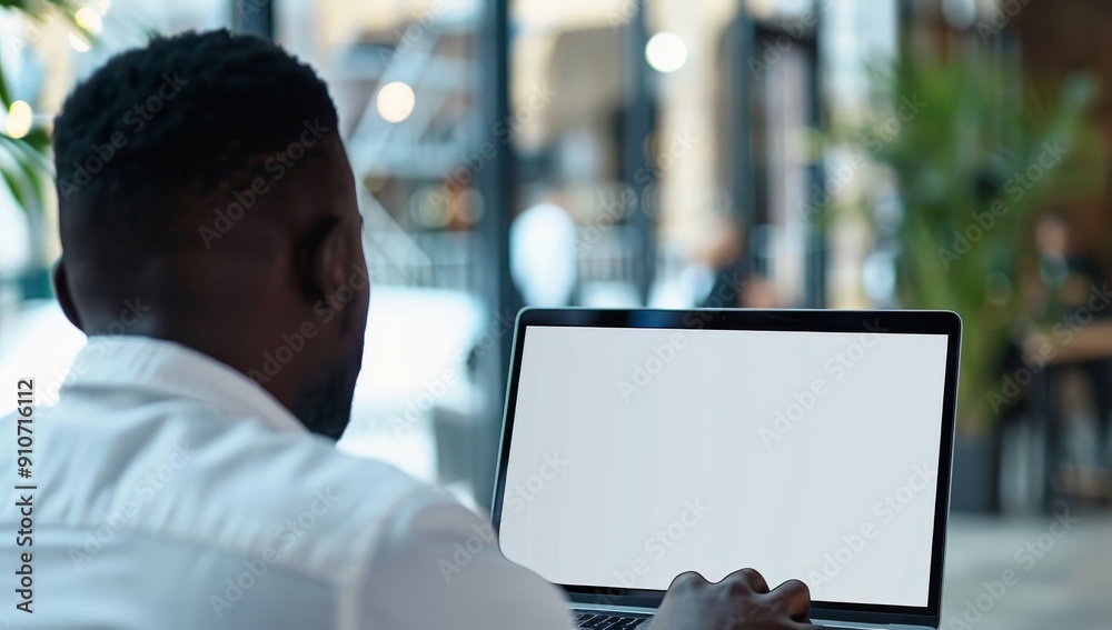 Aufkleber Man Using Laptop with a White Screen in a Blurred Background