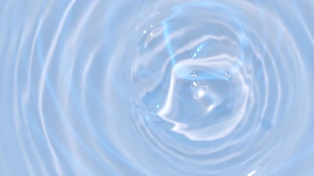 カラフルに変化する水面に落ちた水滴の水輪.