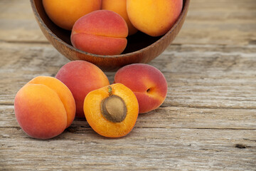 Pile of ripe apricots isolated on rustic wooden table