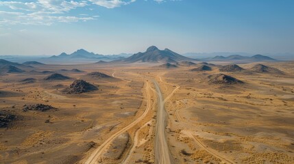 Aerial View of Vast Desert Landscape with Mountains and Clear Blue Sky on a Sunny Day