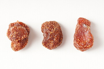 Healthy snack of sweet, pale red dehydrated strawberry candy, photographed against a white background. Scientific name: Fragaria × ananassa.