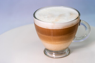 A glass of unmixed cappuccino