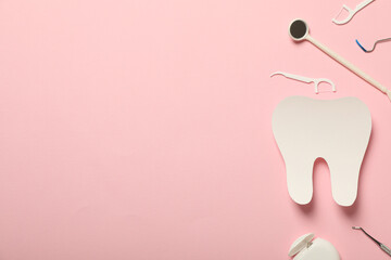 Teeth with dental tools for care, on a pink background.